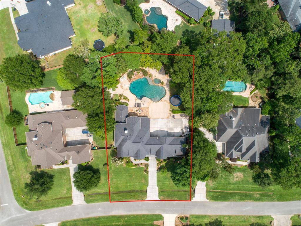 An aerial view of the home on its half acre, private lot.
