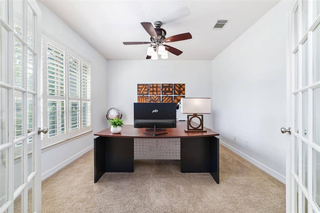 To the left of the foyer is a generous sized home office. The home is adorned with beautiful, functional and timeless plantation shutters throughout.