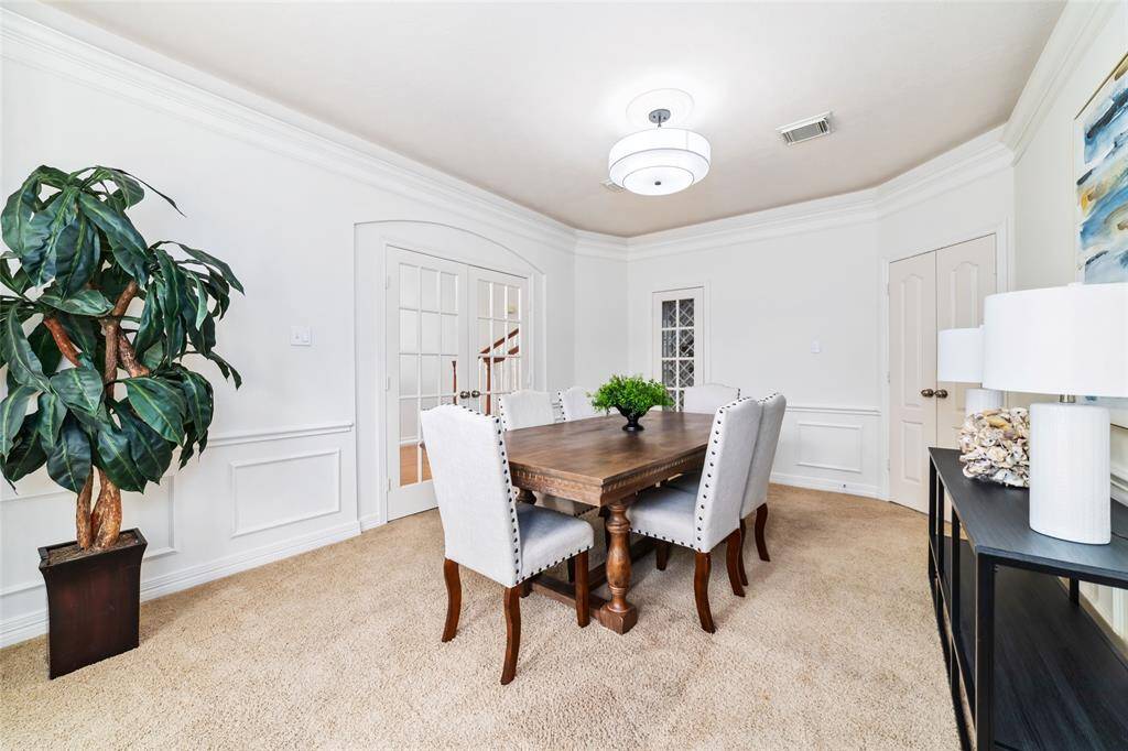 This spacious dining room could easily accommodate a table of ten guests. Effortless entertaining with convenient access to the kitchen.