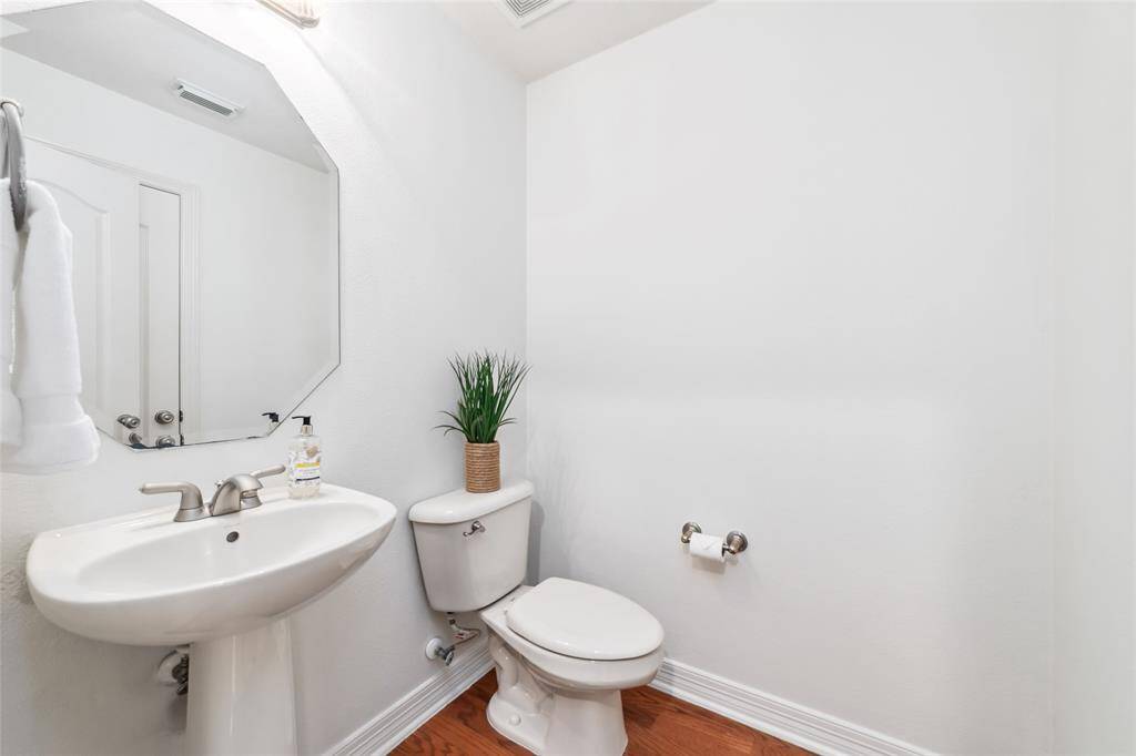 Following the foyer toward the hub of the home, you’ll find a powder room to the left (w/ a dedicated linen closet) and a generous sized closet under the staircase to the right - perfect to tuck away larger items like suitcases, etc…