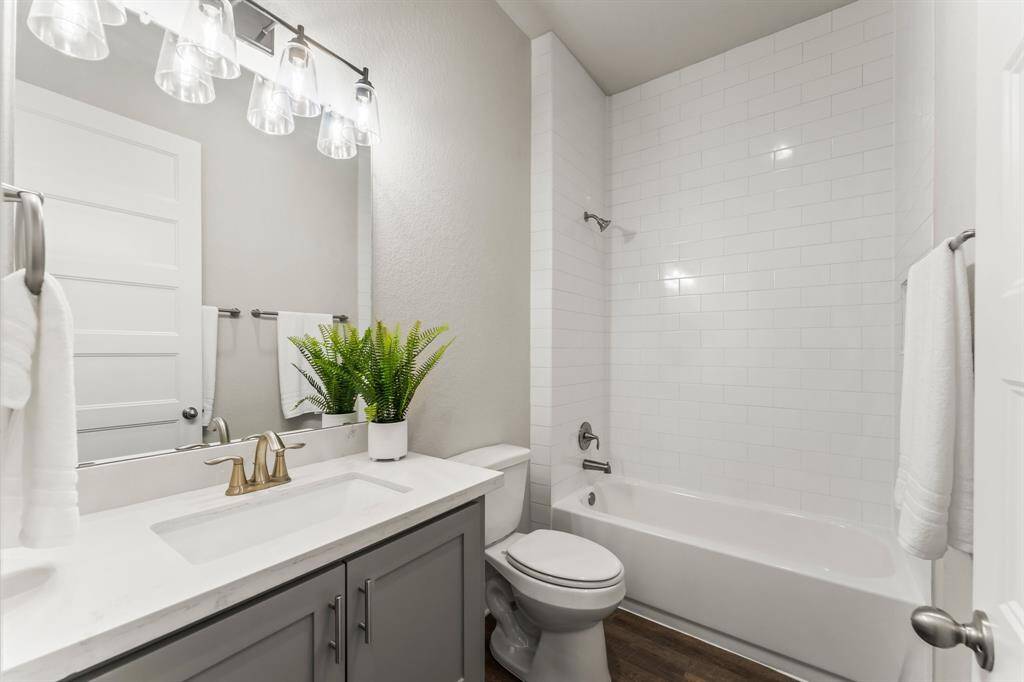 Bathroom #3 is light, bright, and features a tub-shower combo.