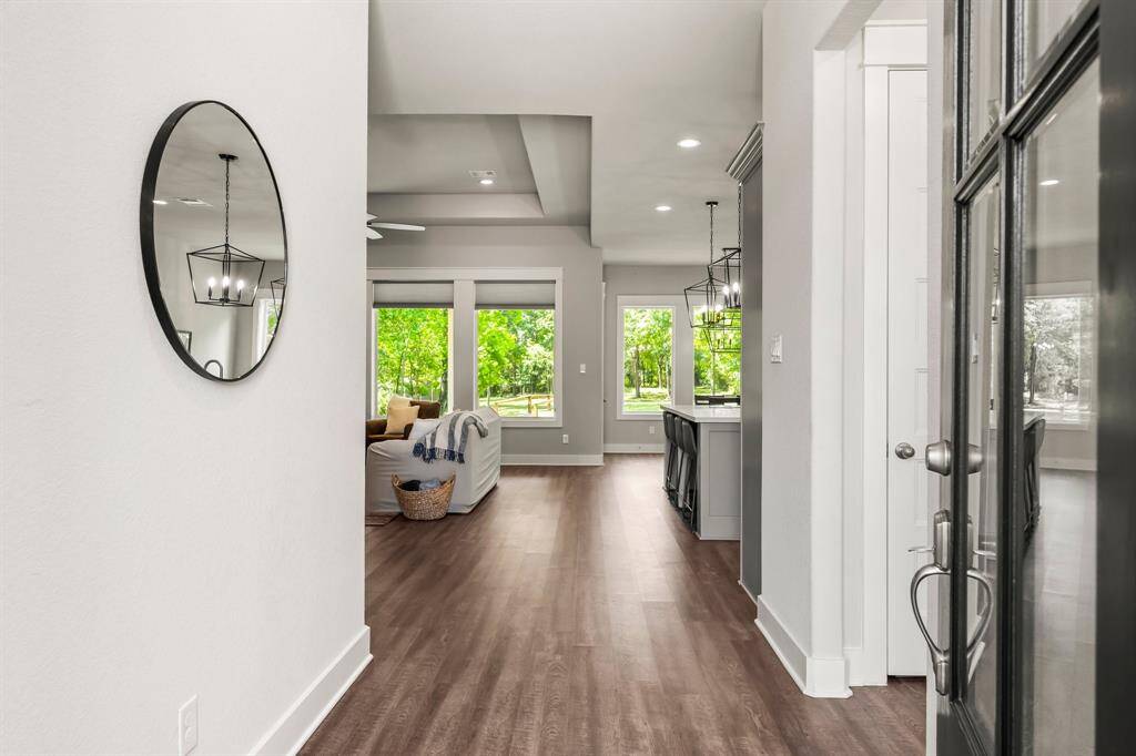 Stepping through the front door, you're immediately welcomed into a spacious, open-concept Living area overlooking the lush backyard.