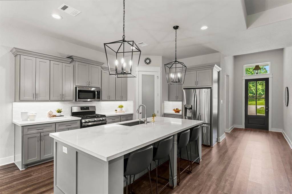 This light & bright kitchen is designed to impress with both beauty & function.  The oversized island is perfect for meal prep, casual dining, or gathering with friends & family.