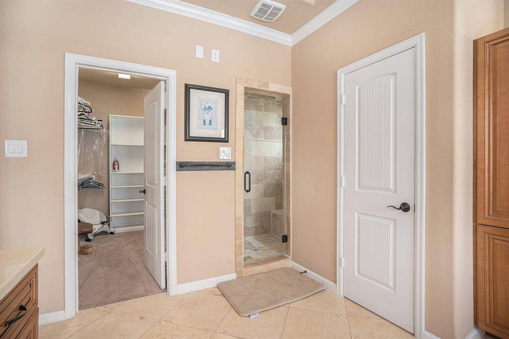 View of primary bathroom with enclosed standing tiled shower