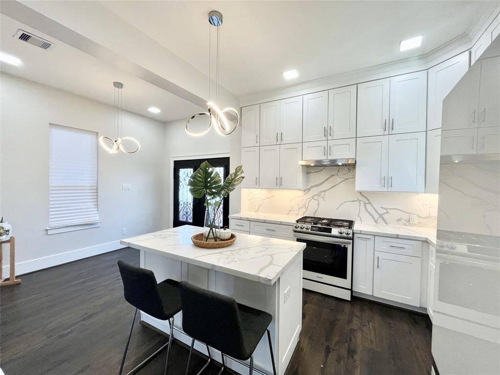 Kitchen features quartz countertops, backsplash and new matching appliances