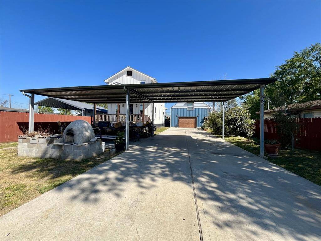 Large double wide driveway and carport allows for over 8 vehicles on the property in addition to the two car garage; front area can be used as a yard, workshop or storage