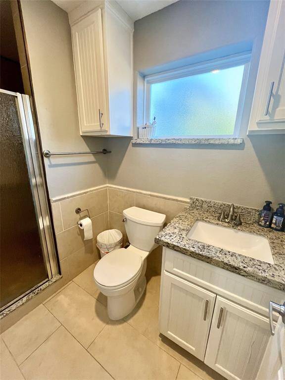 Large full size bathroom with matching countertops and well lit