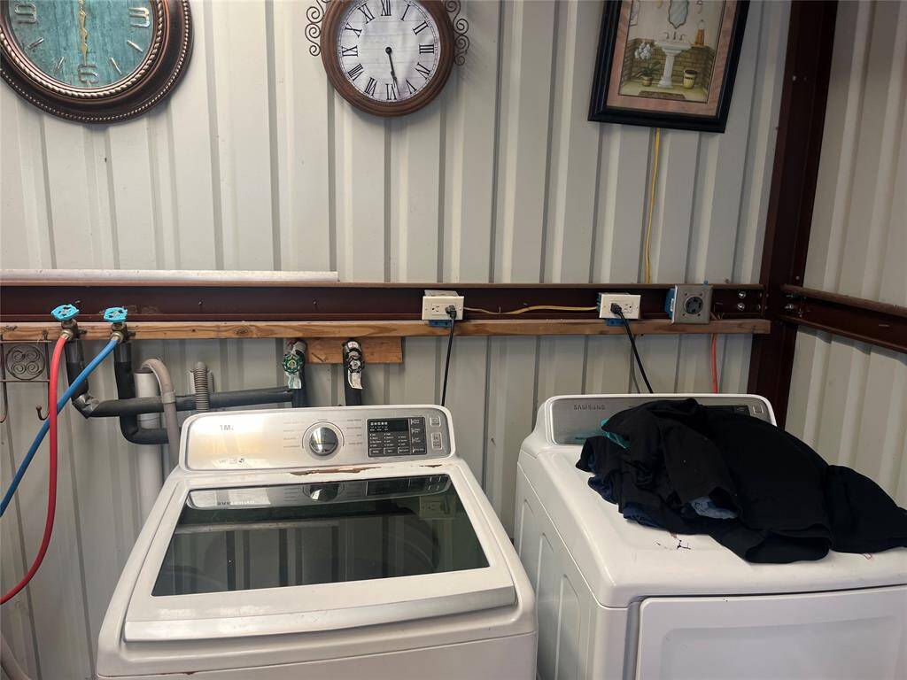 Dedicated utility room at the rear of the property offers additional storage and room for two full sized washers and dryers