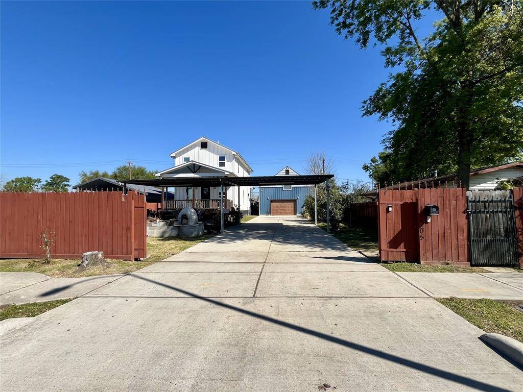 A view from the street and automated gate enclosing the property for maximum security and safety