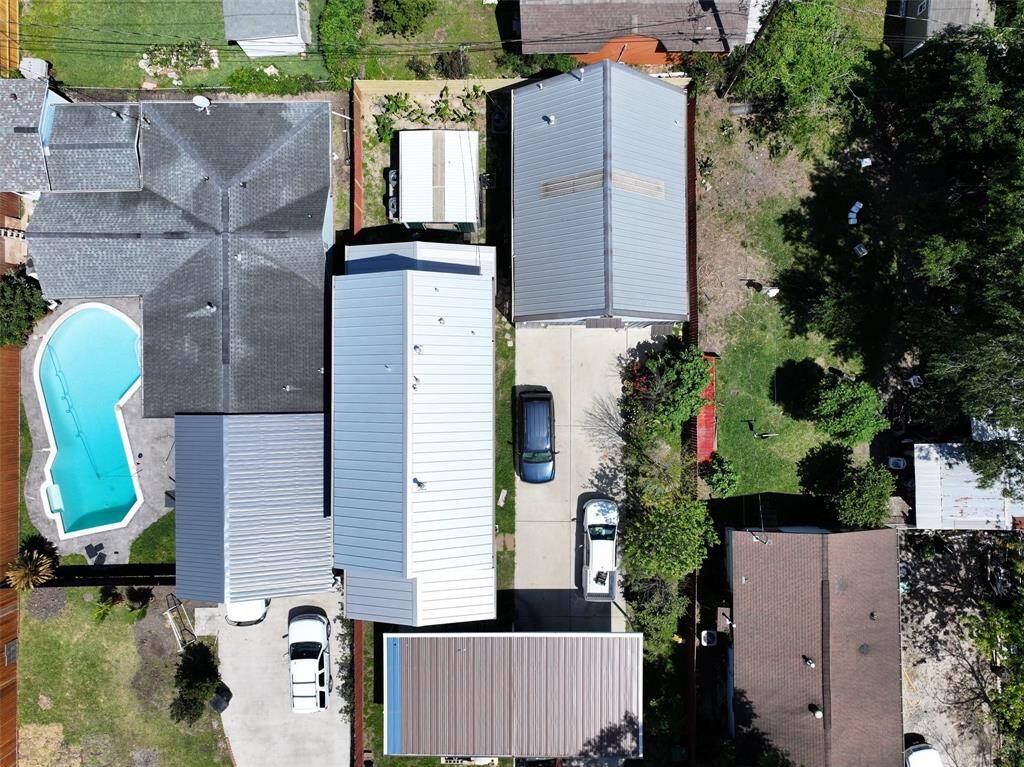 Aerial view of the large 8,400 sq ft 13505 Orleans lot with two full sized single family homes, front yard, car port and rear utility room