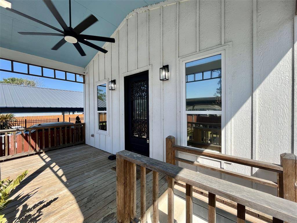 Porch ideal for lounging and hosting, with a large ceiling fan and exterior lighting