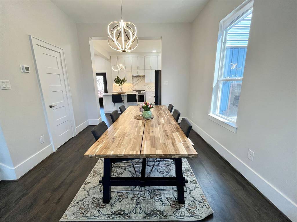 Large dining room can accommodate a table for 8+; modern light fixtures highlight the contemporary-modern blend style of the home