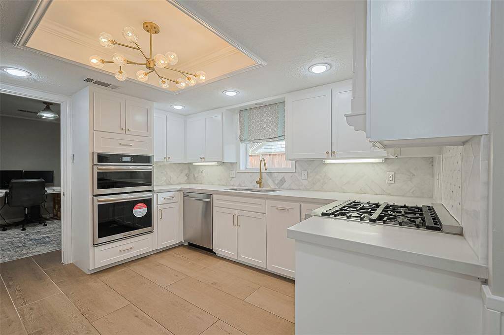 The remodeled kitchen features quartz counters with ss appliances, gas range and new cabinets.