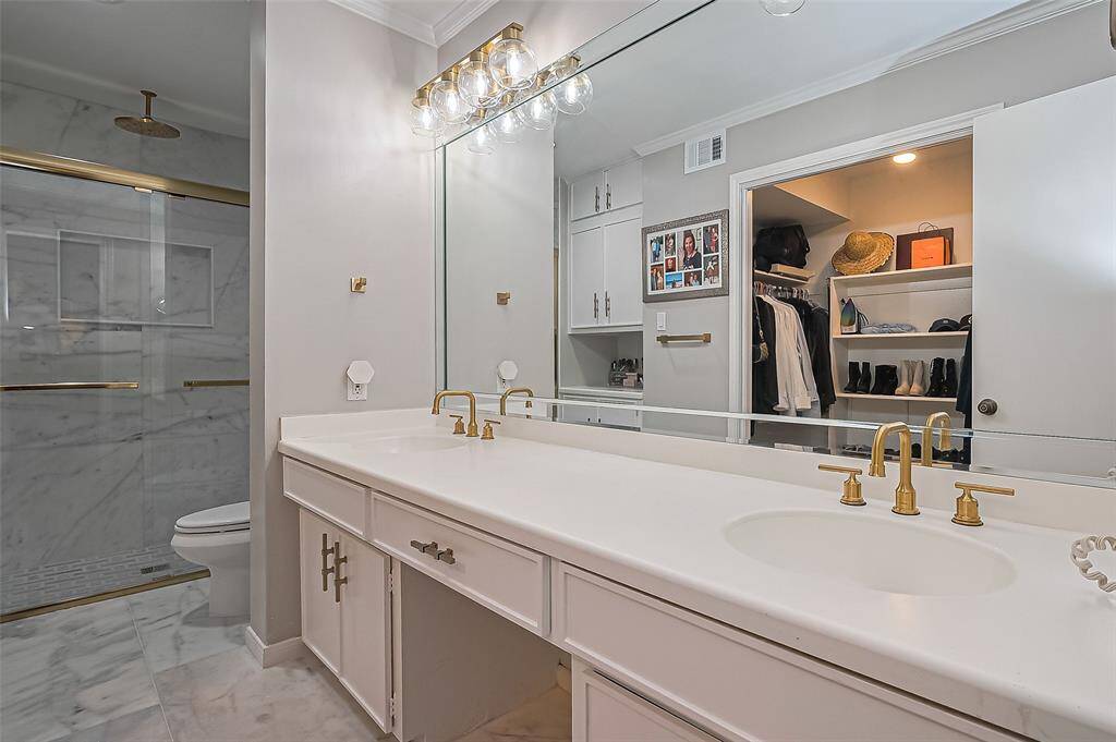 Master bath features double sinks and marble floors.