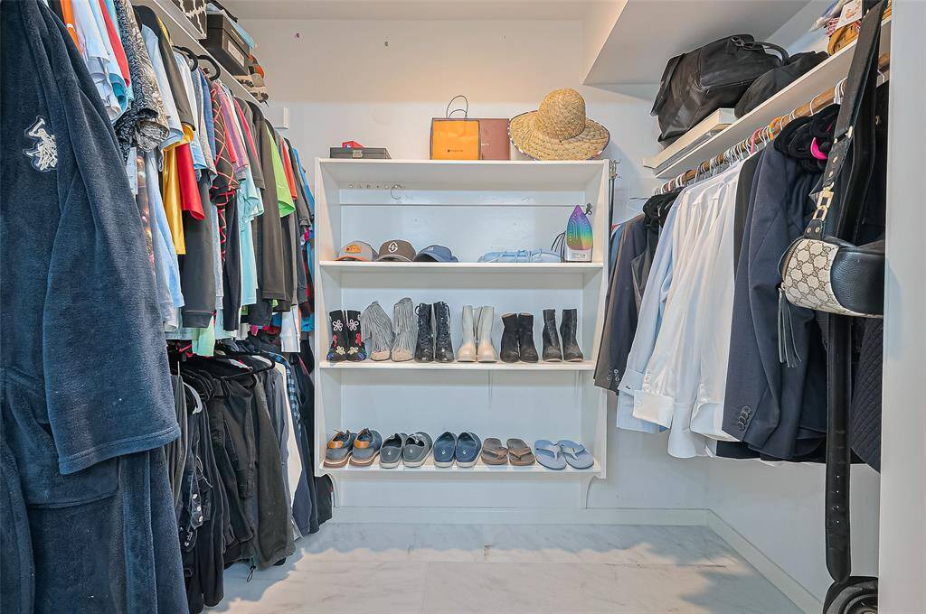 Spacious walk in closet in the primary bedroom with built ins.