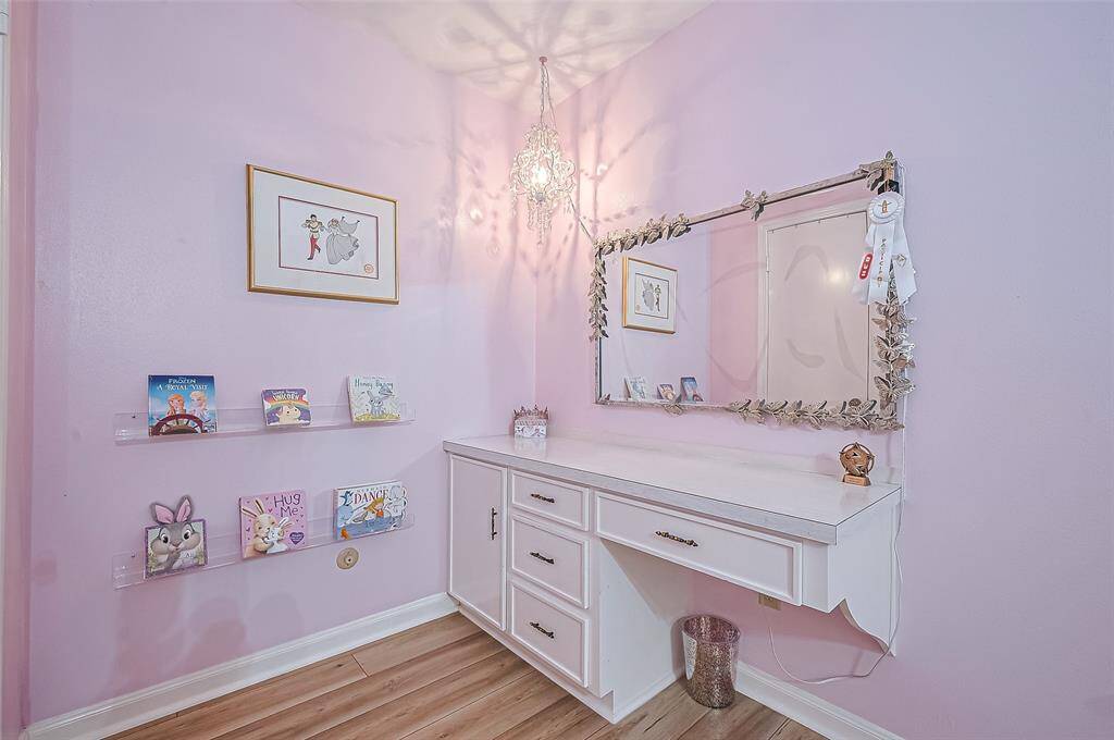 Another view has a built in desk and walk in closet.