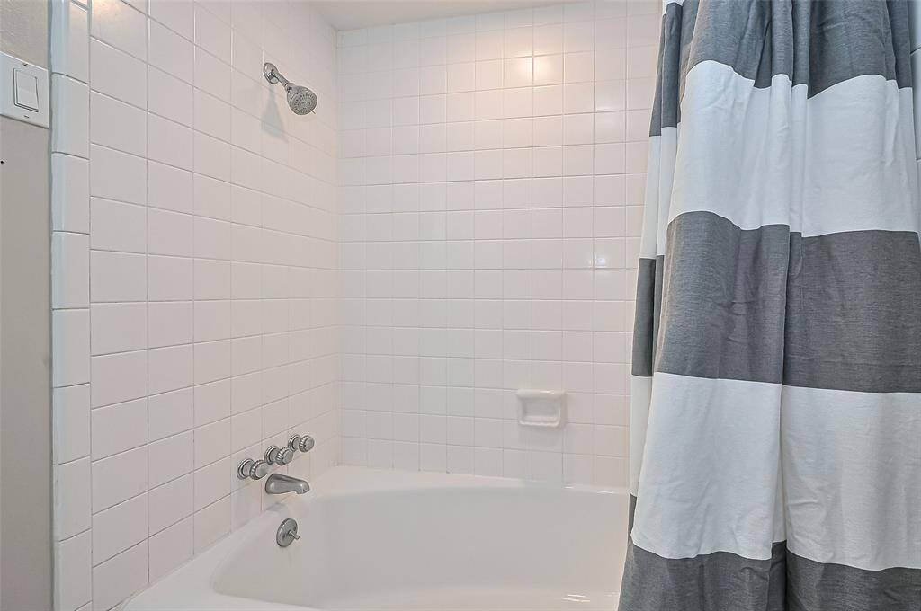 The second bath has tub with shower has tile.