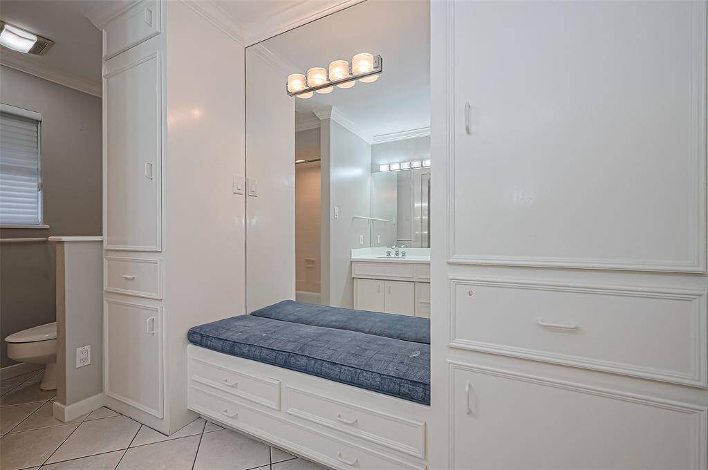 The 2nd bath has a cute seat and extra storage.