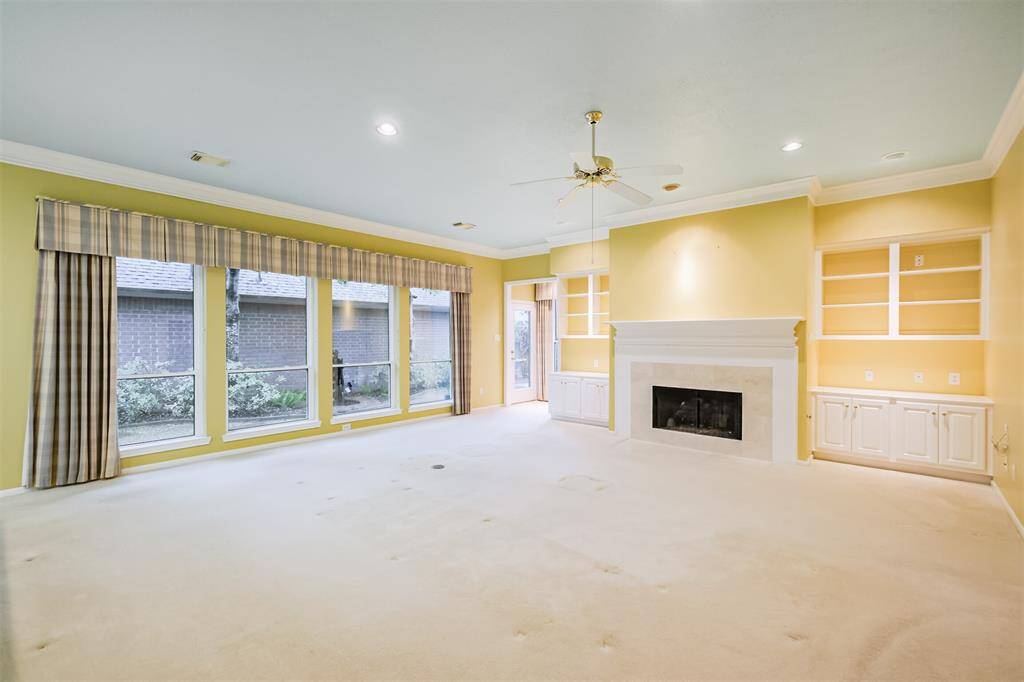 Family room is bordered by windows allowing for maximum natural light.