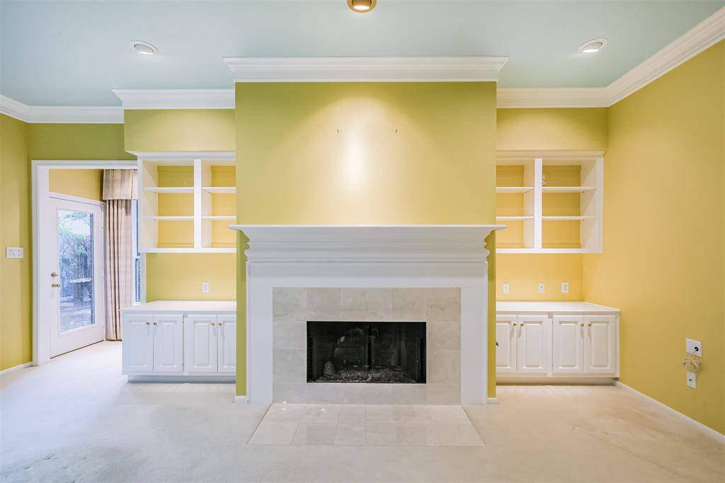 Built-ins for ultimate storage surround a gas log fireplace.