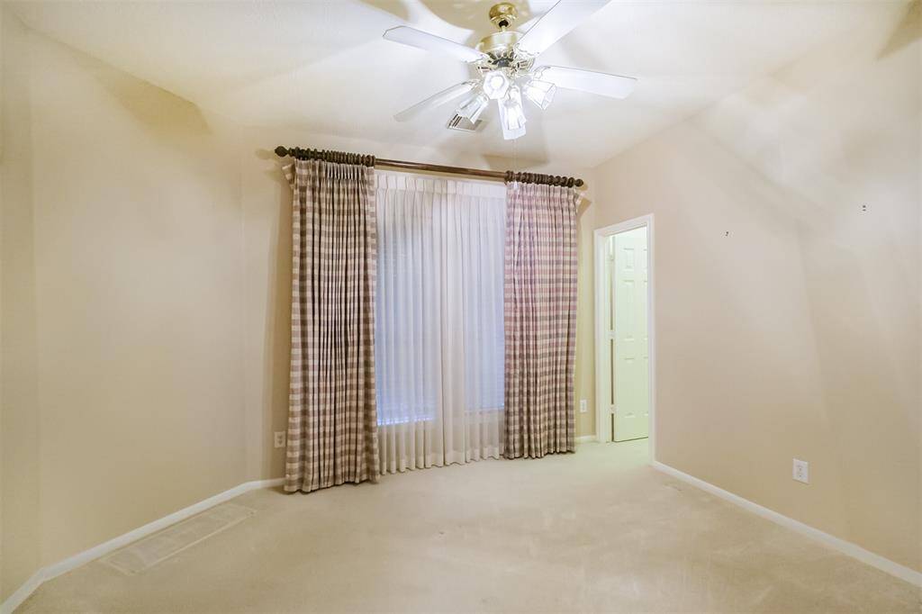 Secondary bedroom with walk-in closet. large windows let in natural light.
