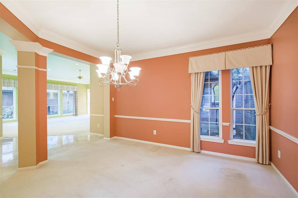 Dining room has large window looking into the atrium.