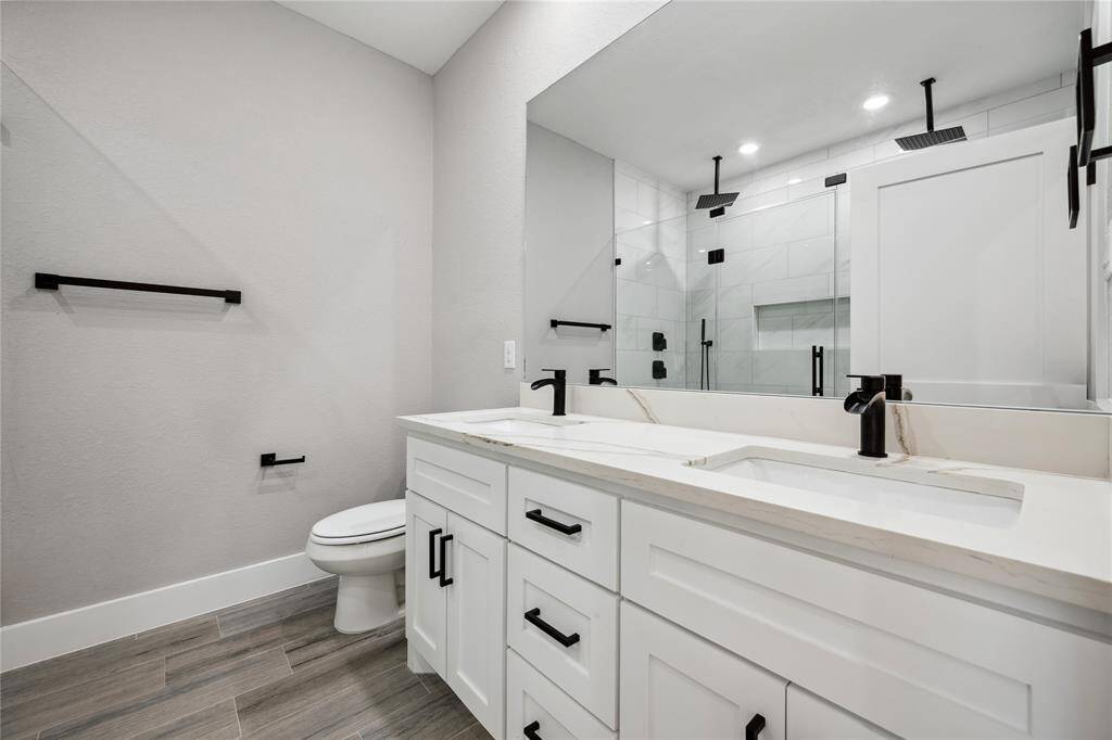 Primary bath has dual sinks, quarts countertops, upgraded faucets and fixtures and a large shower with dual rain heads.