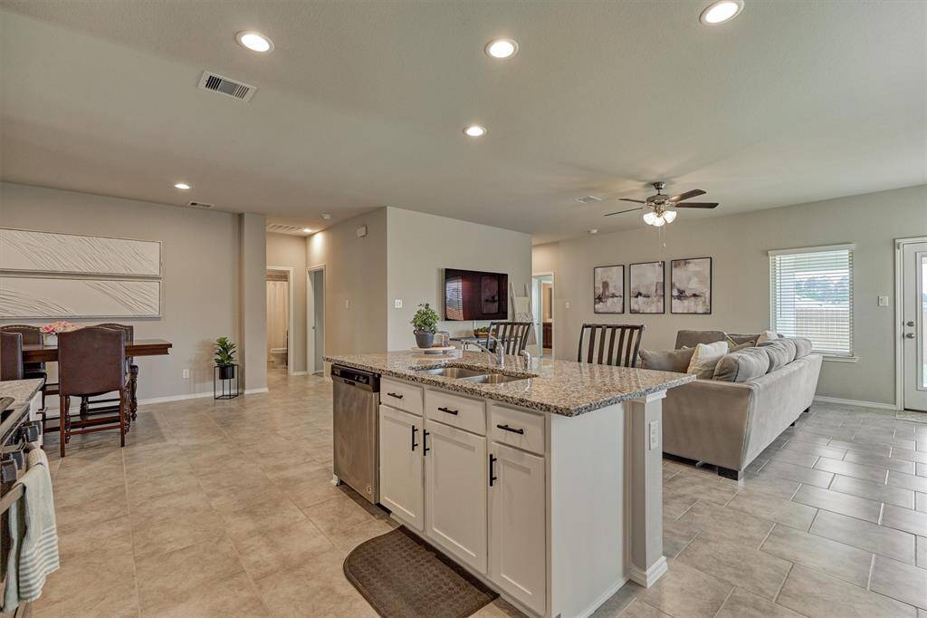 The hallway to the right of the dining room leads to the remaining secondary bedrooms and a full bathroom.