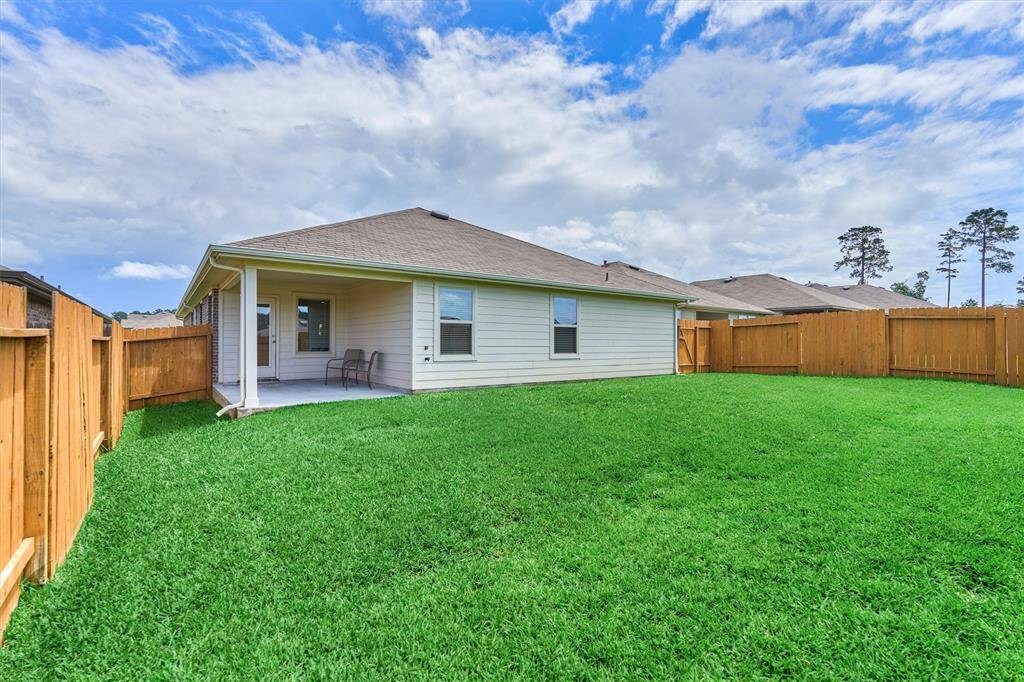 The large back yard has plenty of space for your own playground equipment or for running and playing.
