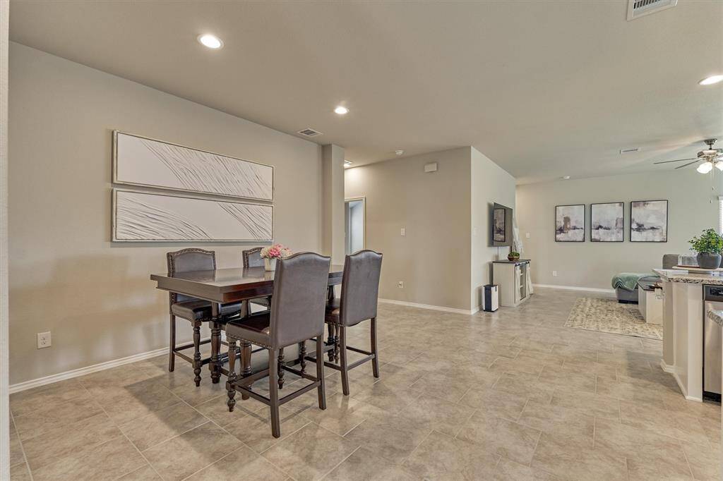 Stepping into the main living area from the foyer, you'll see the dining area on your left and the kitchen on your right.