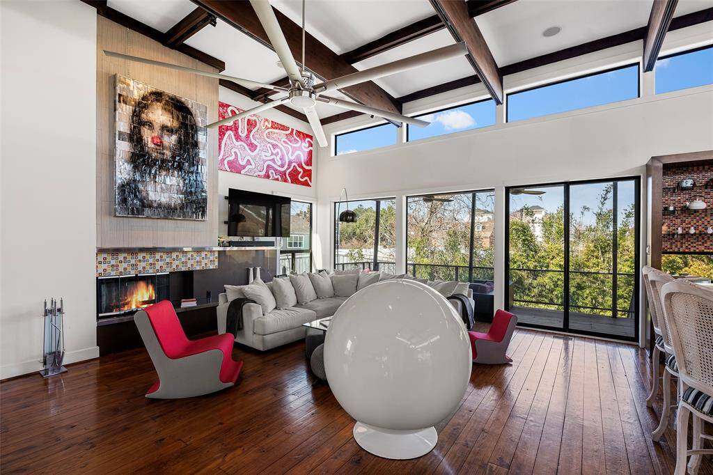 This spacious living room offers a seamless flow to the outdoor views. Smart home features surround sound. Perfect for entertaining or relaxing!