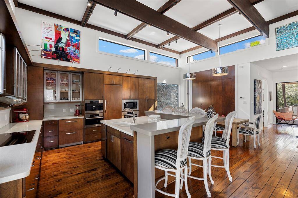 In this view you can appreciate the chandeliers, extra pantry space and wrap around island.
