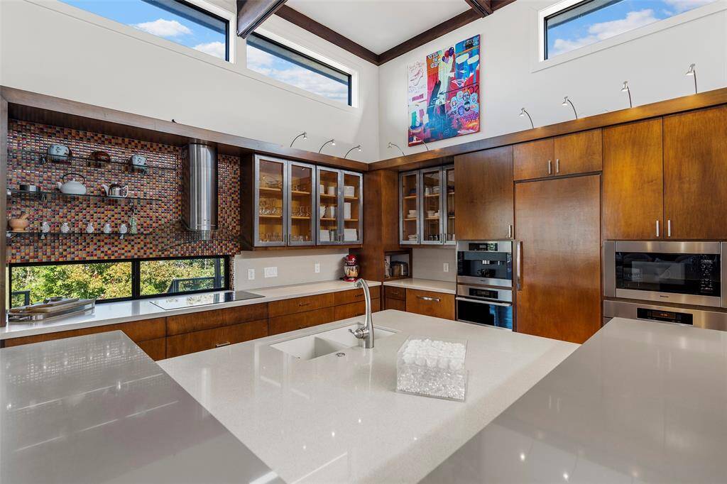 Durable stone island, custom build cabinets as well as metal and glass front cabinets tie this home together perfectly.