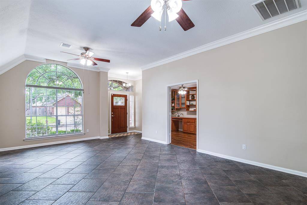 View of living/dining and door into custom office