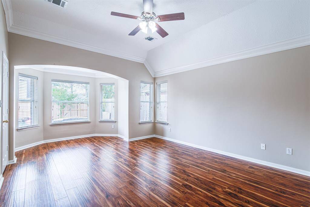 Beautiful primary bedroom with tall ceilings and view of the pool.
