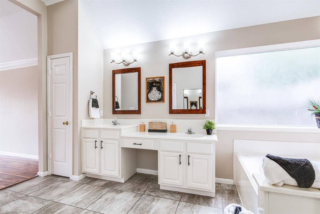 Double sinks in primary attached bath with space for makeup.  Jetted tub and separate shower.  Great size bath.