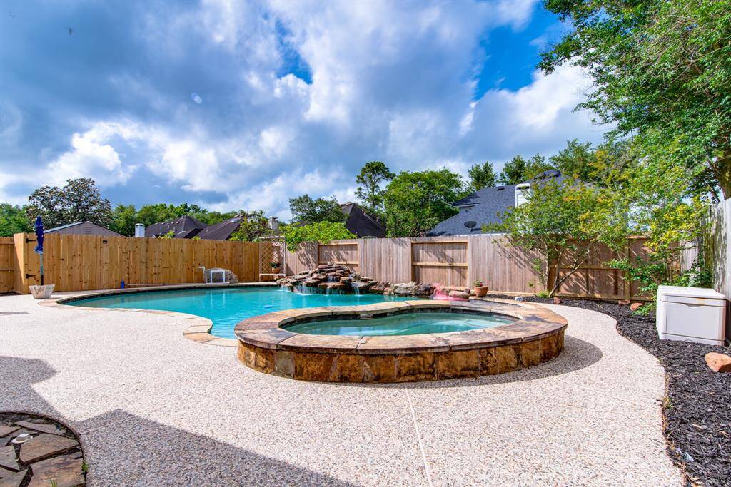 Gorgeous entertaining pool, spa and backyard.  Plenty of room for friends and family.  You will enjoy it all summer long.  Notice the rock waterfall.