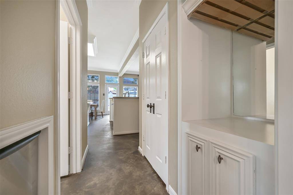 Tucked just off the kitchen, this built-in bar station includes upper stemware storage, a mirrored backsplash, and a dedicated icemaker—perfect for entertaining.