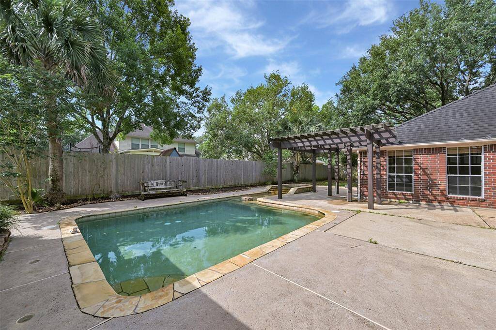 Enjoy endless summer fun in this private backyard retreat, complete with a sparkling pool, raised spa, and a pergola-covered patio—perfect for lounging or dining al fresco.