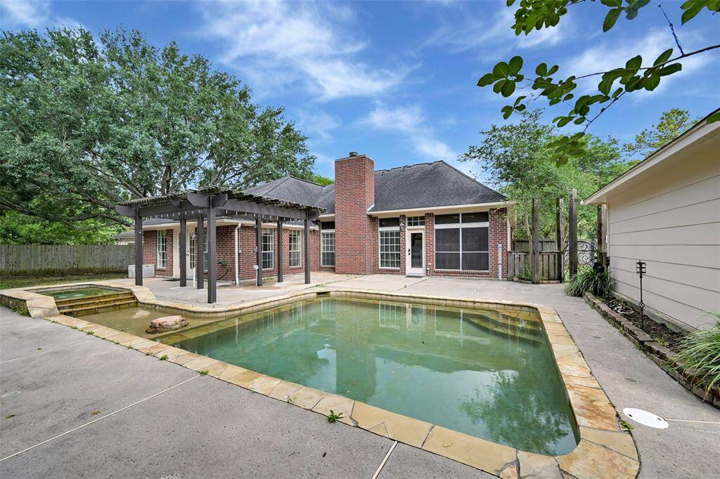 Enjoy endless summer fun in this private backyard retreat, complete with a sparkling pool, raised spa, and a pergola-covered patio—perfect for lounging or dining al fresco.