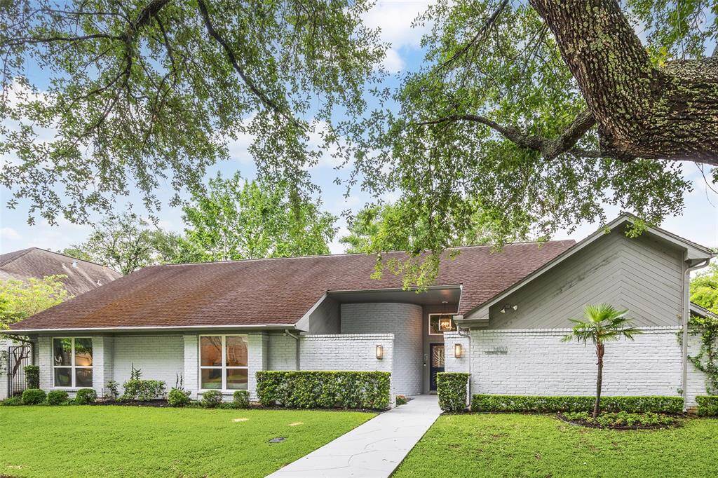 Nestled on a desirable corner lot in West Memorial, the home's thoughtful orientation and mature greenery offer a sense of privacy rarely found in the neighborhood. The single-story profile and clean exterior lines highlight the tasteful renovations within.
