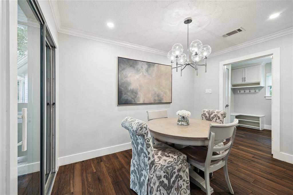 Sunny breakfast room and a peek into the adjacent utility room—featuring a built-in bench and ample storage cabinets for effortless organization.