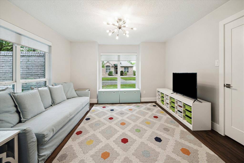 This versatile space off the living room has a large walk-in closet and can easily serve as a fourth bedroom, home office, or game room, offering flexibility to fit your lifestyle needs.