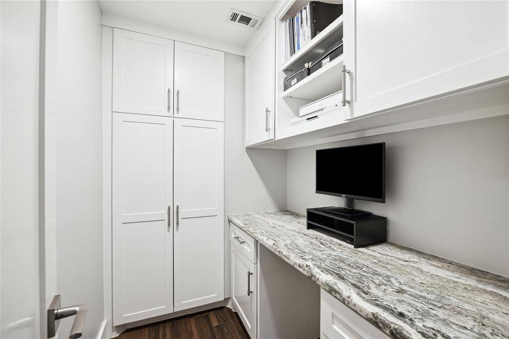 Tucked away between the living room and bedrooms is a built in office area with plenty of cabinetry for extra storage.