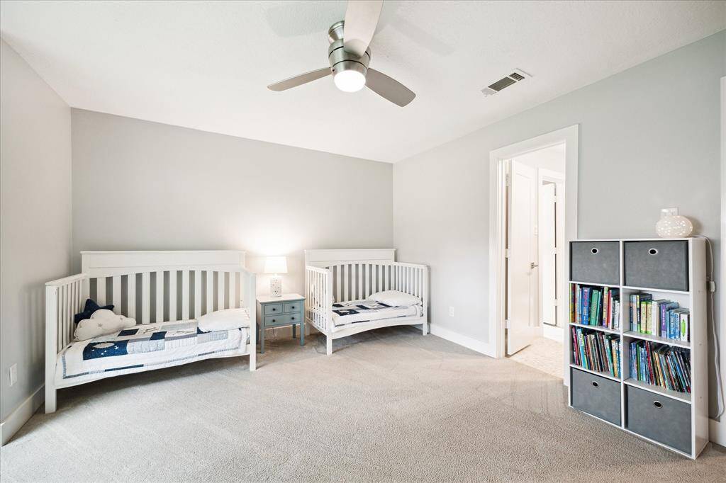 This spacious secondary bedroom offers plenty of natural light and ample closet space. It also connects to a Jack and Jill bathroom.
