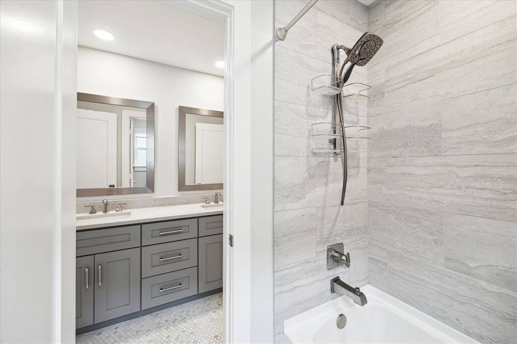 Secondary bathroom offers sleek modern finishes. The shower and toilet are separate from the vanity to allow privacy.