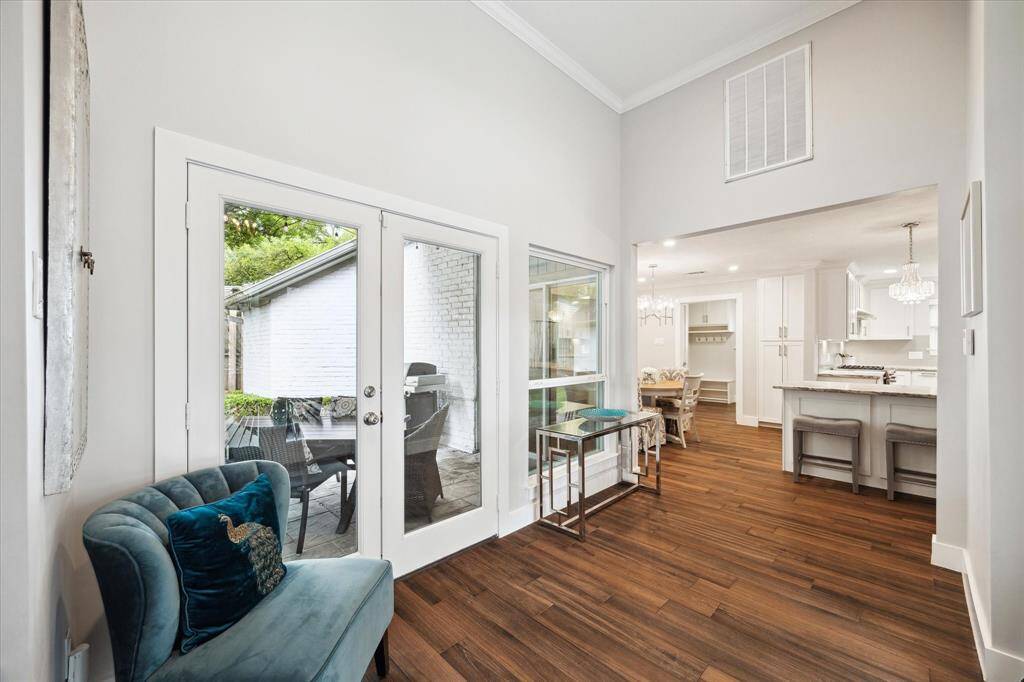 Spacious entry with double doors to the back patio area. The kitchen and dining areas are to the right.
