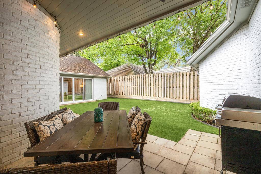 The private backyard offers a private retreat with an always green AstroTurf lawn for low-maintenance outdoor enjoyment. The area provides plenty of room for relaxation or entertaining.