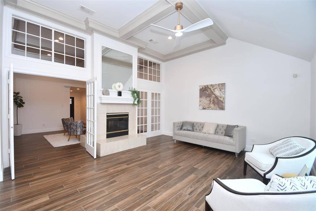 Family room off kitchen with new designer lighting overlooking the entertaining back yard patio