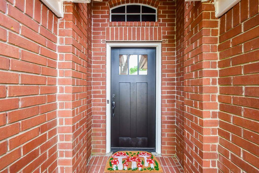 Beautiful brick and luscious landscaping greet you as you drive up